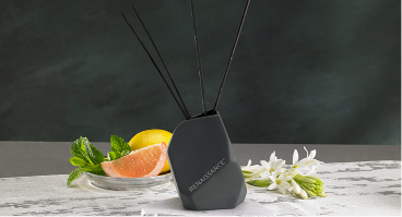 Reed diffuser with oranges behind